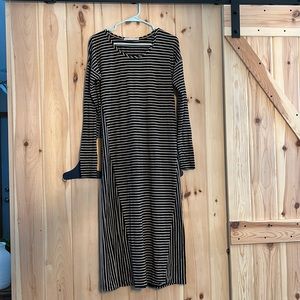 Long sleeved, black and taupe striped full length dress.